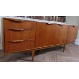 McIntosh teak sideboard fitted with two cupboard doors, a fall door and three short drawers, upon