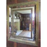 A contemporary wall mirror in an antique style, the deep moulded frame with further mirror panel
