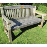 A weathered pine garden bench with slatted seat and back, 155cm long