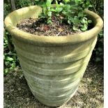 A weathered garden planter of tapering ribbed form (af) 70cm high