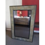 A contemporary wall mirror with simulated bark framework, within ebonised boarder, 120cm x 80cm