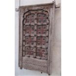 An antique Indian hardwood panel with carved detail, the centre section in steel and brass overlaid,