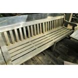 A good quality weathered teak garden bench, 240cm wide