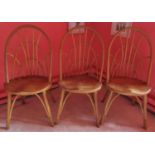 Set of three contemporary rustic Windsor style hoop back dining chairs, the dished seats in elm