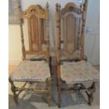 Four 20th century oak dining chairs in the carolean manner with cane panelled seats and backs (af)