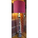 A turned timber lamp standard, with repeating baluster turned stem raised on a circular disc base,