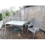 Six lightweight metal garden chairs with panelled seats and back together with a matching table