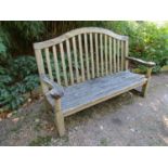 A weathered teak wood garden bench, 160cm wide