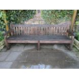 A good quality weathered teak park bench, 240cm wide