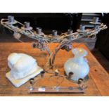 A moulded plaster figure of a crouching dove, an arched candelabra with seven candle sconces, a