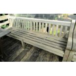 A good quality weathered teak garden bench, 240cm wide