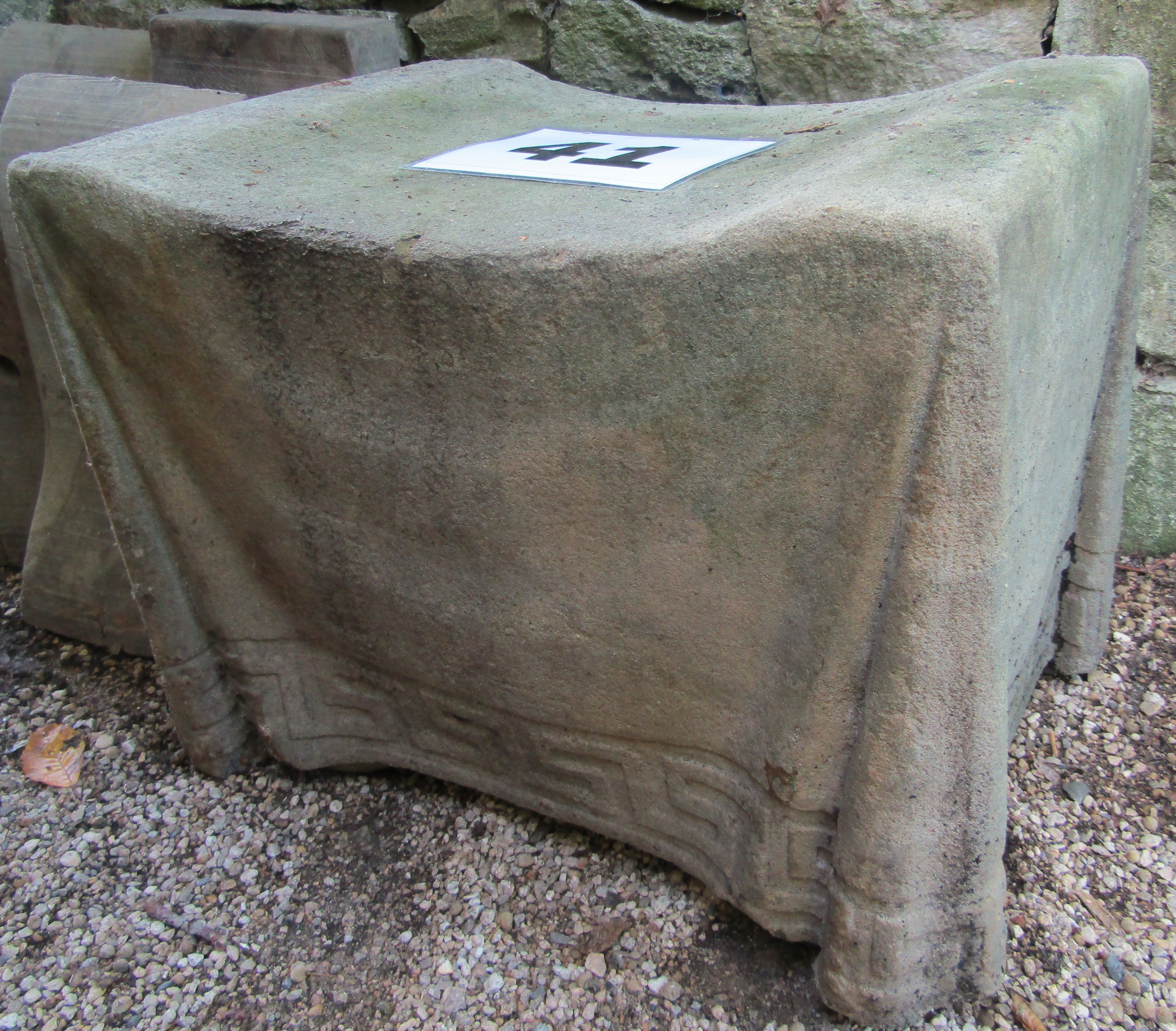 A concrete stool with simulated fabric finish