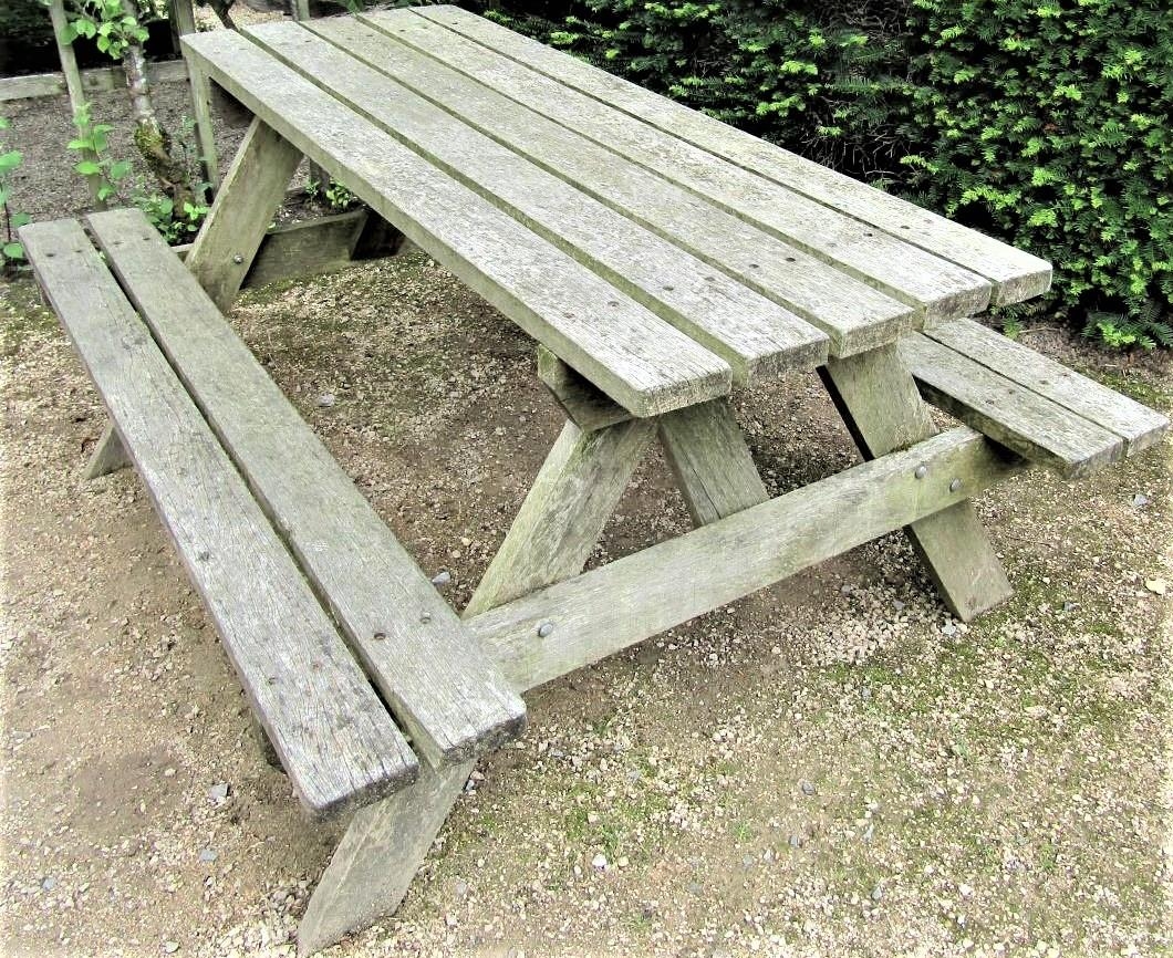 A weathered teak picnic table, 152cm long