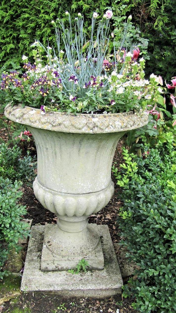 A reclaimed campana shaped garden urn with fluted panels, within egg and tongue borders, 75cm high