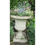 A reclaimed campana shaped garden urn with fluted panels, within egg and tongue borders, 75cm high