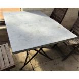 A vintage style café table, the rectangular top zinc lined, 120cm x 80cm, raised on an ironwork base