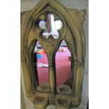 A pair of contemporary Gothic revival wall mirrors, the bases enclosing two candle sconces, 72cm
