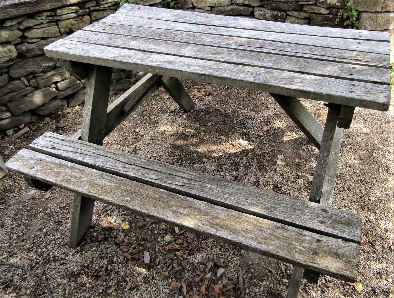 A weathered teak picnic table, 122cm long