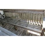 A good quality weathered teak garden bench, 240cm long