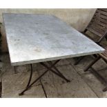 A vintage style cafe table, the rectangular top zinc lined, 120cm x 80cm, raised on an ironwork base