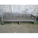 A good quality teak garden bench, 240cm long approx