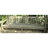 A weathered teak wood garden bench, 240cm wide, reduced in height