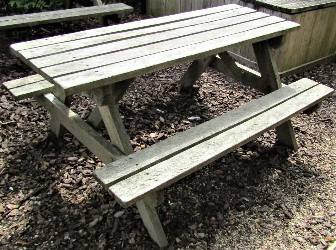 A weathered teak picnic table, 152cm long