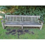 A good weathered teak wood garden bench, 240cm wide