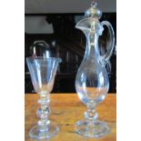 A hand blown glass with hollow knopped stem, together with a further hand blown decanter with loop