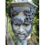 Pair of reconstituted stone green man wall bosses overlaid in lead