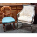 A French style tub chair with painted wooden frame, upholstered in pale yellow fabric, depicting