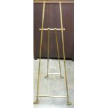 Edwardian style brass easel, square section frame and scroll decorated feet, height 159 cm