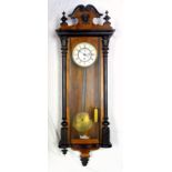 Viennese regulator wall clock, walnut and ebony case with mask decoration, enamel dial with Roman