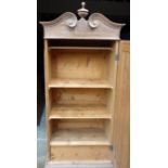 19th century Hungarian pine cupboard with split pediment and turned finial, above door enclosing