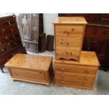 A group of modern pine furniture, a blanket box by Ducal, a low chest of drawers and a bedside chest