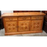 A contemporary sideboard in solid blond wood, with marquetry design, three drawers over three