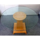 Contemporary round breakfast table with central beech pedestal and glass top, 99 cm diameter.