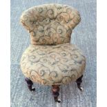 Victorian nursing chair upholstered in tapestry style fabric, on shaped mahogany legs with castors