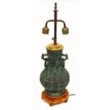 Decorative table lamp in the form of a Chinese bronze baluster vase with ring handles, twin brass