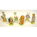 Beatrix Potter figures, Beswick Peter Rabbit gardening, Tommy Brock and Foxy, and Royal Albert