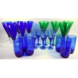 A group of blue and green conical form wine glasses, a Nailsea type rolling pin and other drinking