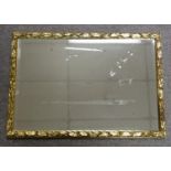 Rectangular wall mirror with a bevelled plate, in a gilt moulded leaf and berry frame, 56.3 x 81.6cm