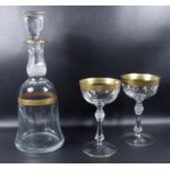 Bell form decanter and two glasses with gold overlay and finely cut bands, possibly Moser decanter