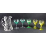 Glass jug engraved with water lilies, height 19 cm and a group of coloured wine glasses including