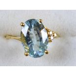 Aquamarine asymetric gold dress ring with three small diamonds, 14 ct