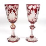 A pair of 19th Century Bohemian glass goblets, ruby flashed wheel cut decoration of Bacchus among