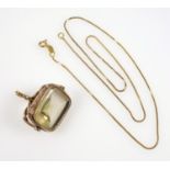 Citrine set fob, the mount with engraved floral decoration unmarked yellow metal, with modern fine