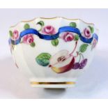 An unusual Chelsea tea bowl, C. 1750, fluted form painted with scattered fruit, with pink rosebud