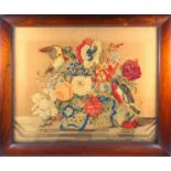 An unusual mid Victorian woolwork, two dimensional scene of two birds in a basket of flowers, the