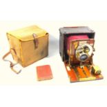 The Sanderson Regular plate camera with leather covered mahogany body, brass parts & red bellows,